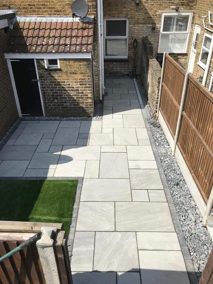 Patio area and artificial garden by Admire Landscapes